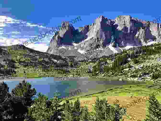 Panoramic View Of A Serene Lake In The Wind River Range, With Snow Capped Mountains In The Distance. On Fly Fishing The Wind River Range: Essays And What Not To Bring (Narrative)
